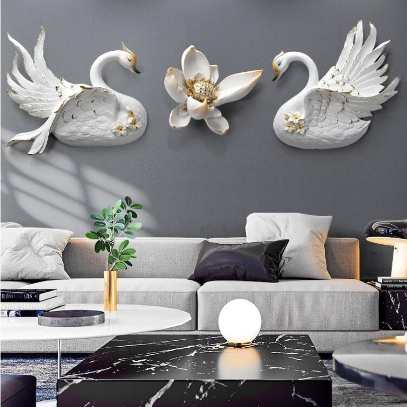 Elegant swan figurine wall decoration hanging above a couch.