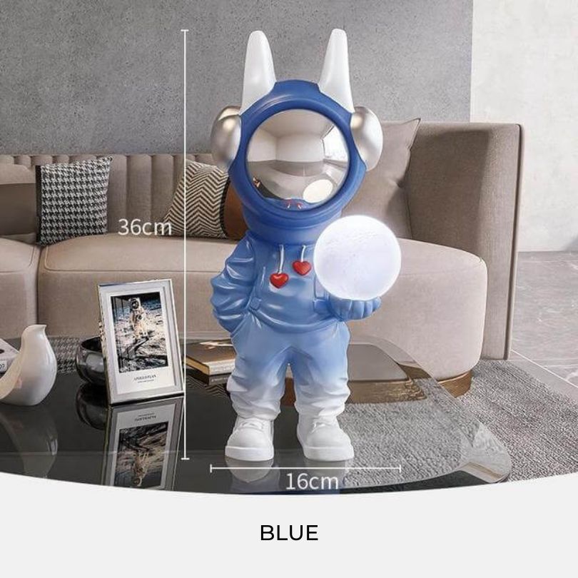 Astronaut statue with light displayed on a modern office desk, creating a calming atmosphere.