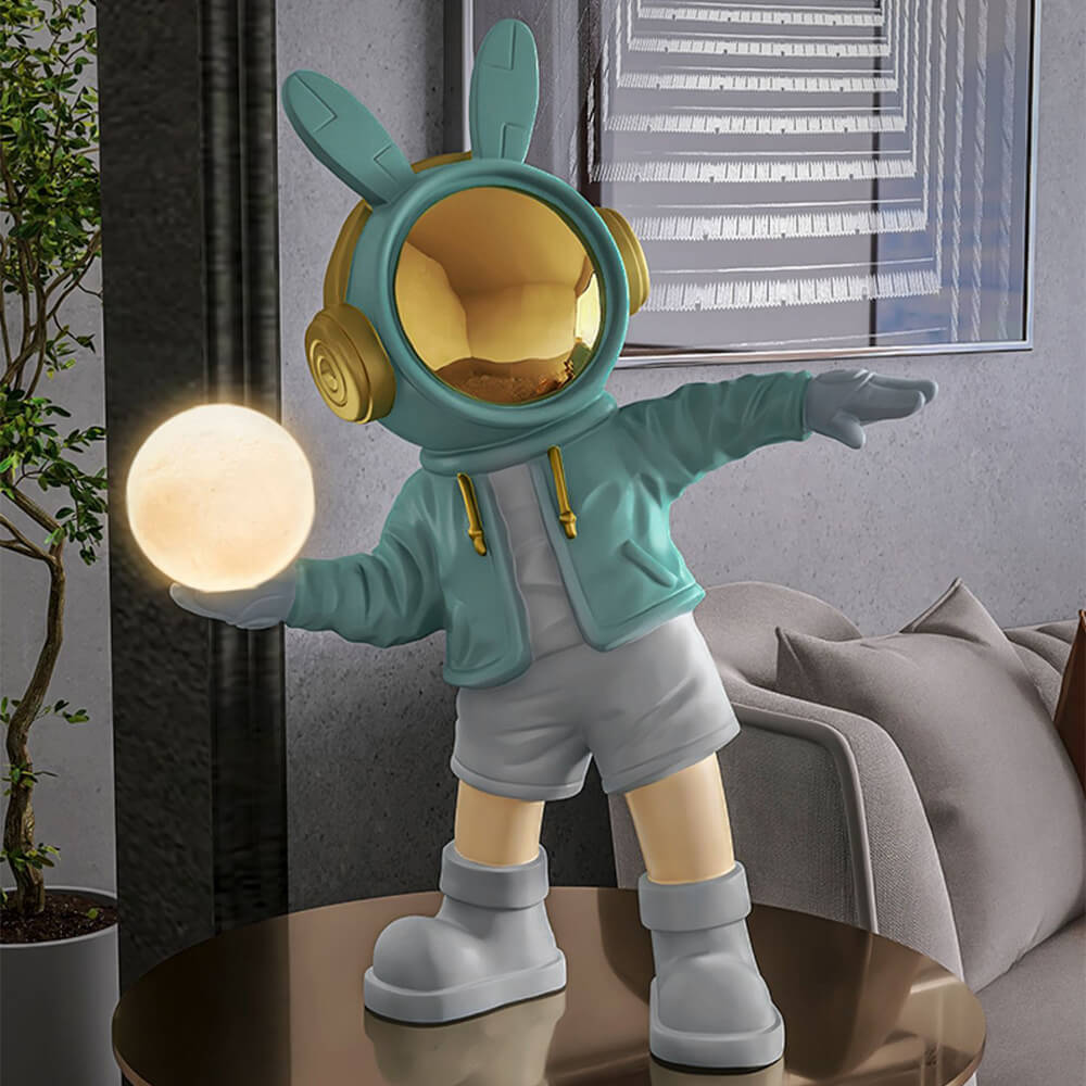 Astronaut statue with light displayed on a modern office desk, creating a calming atmosphere.