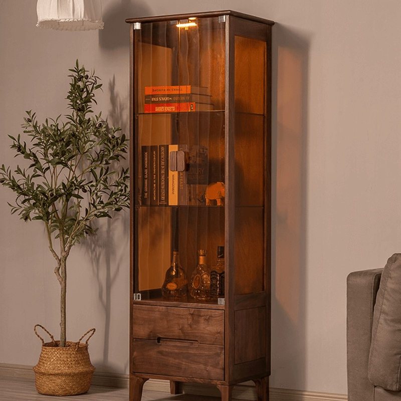 Front view of the elegant tall glass display cabinet showcasing collectibles.