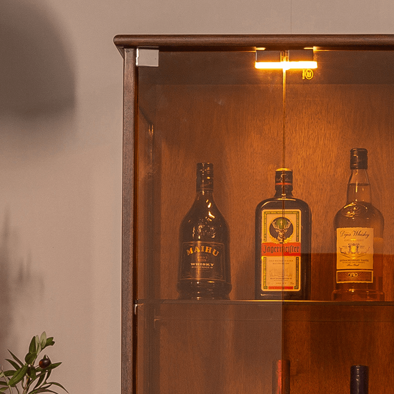 Front view of the elegant tall glass display cabinet showcasing collectibles.