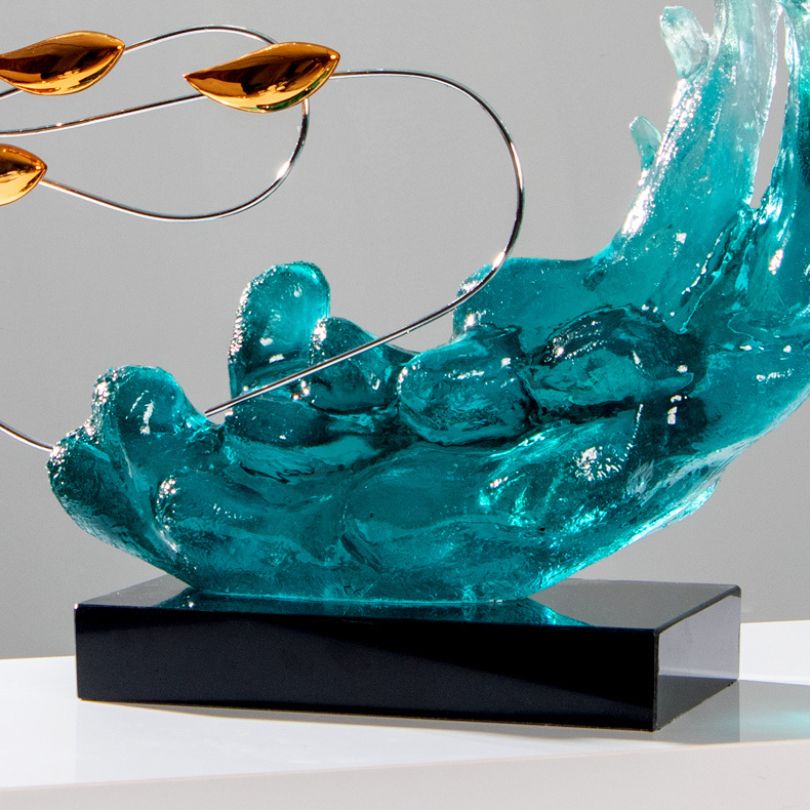 Serene Blue Wave Resin Sculpture displayed in a modern living room, highlighting its calming blue color and elegant design.