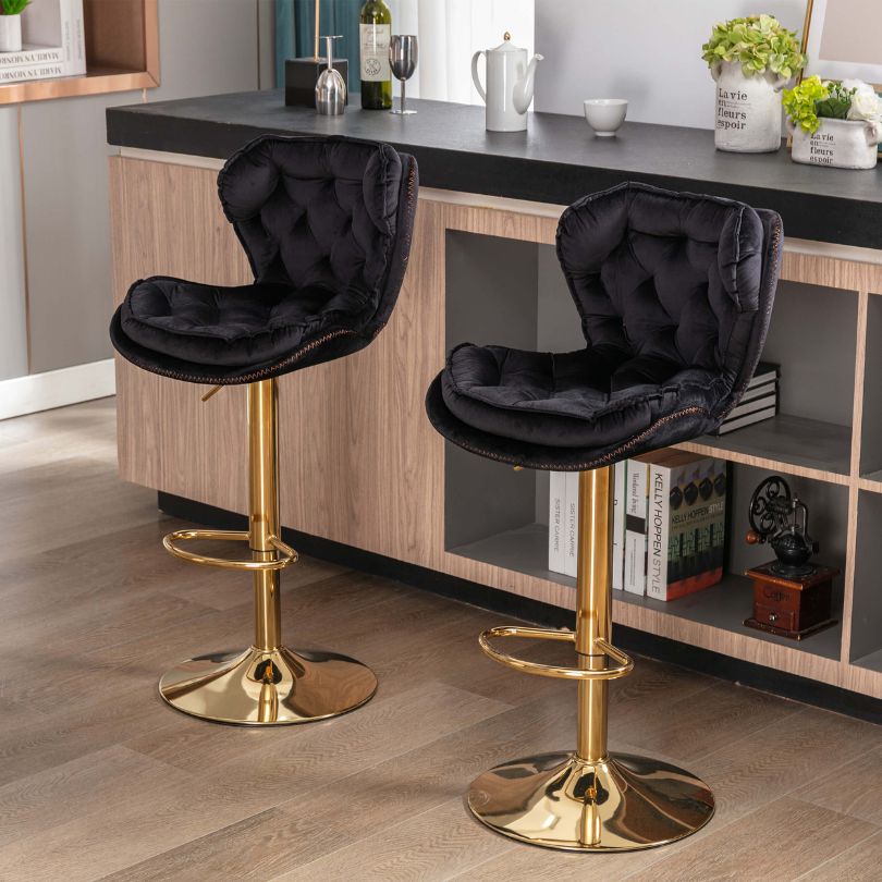 Close-up view of luxury bar stools with velvet upholstery showcasing tufted design.