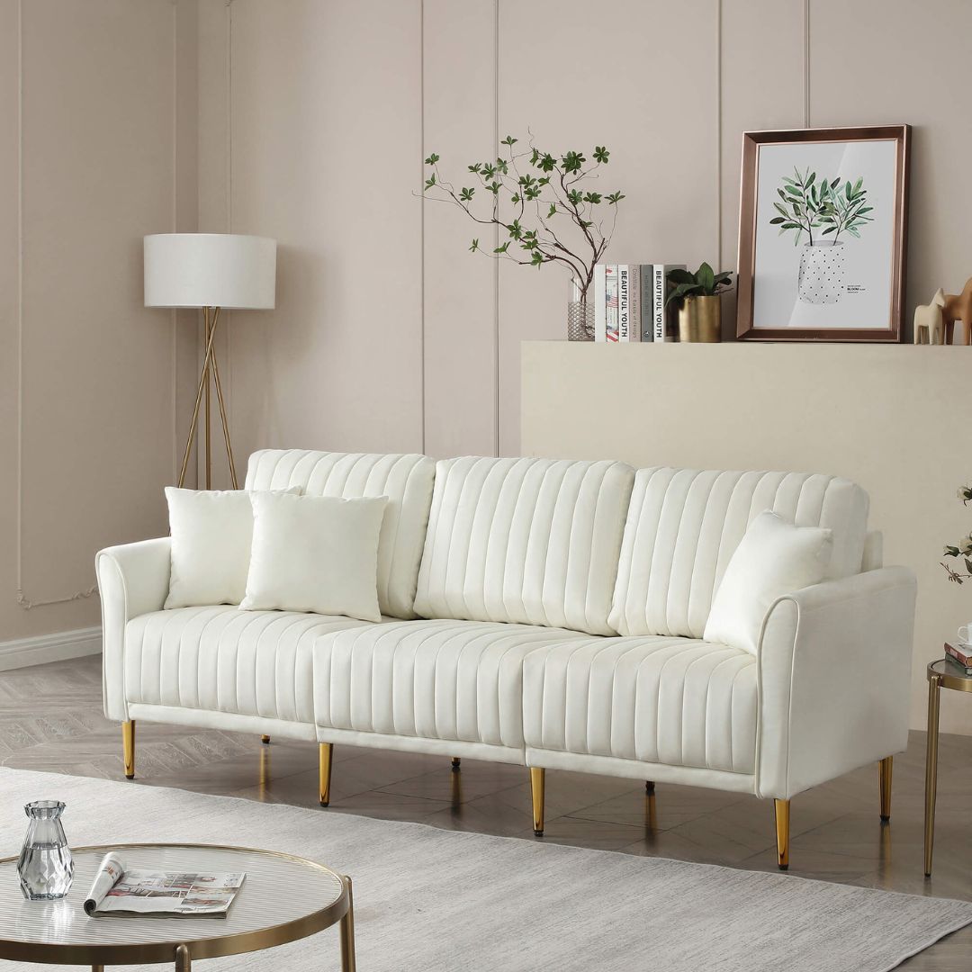 Elegant cream velvet 3-seater sofa showcasing tufted details and gold metal legs.