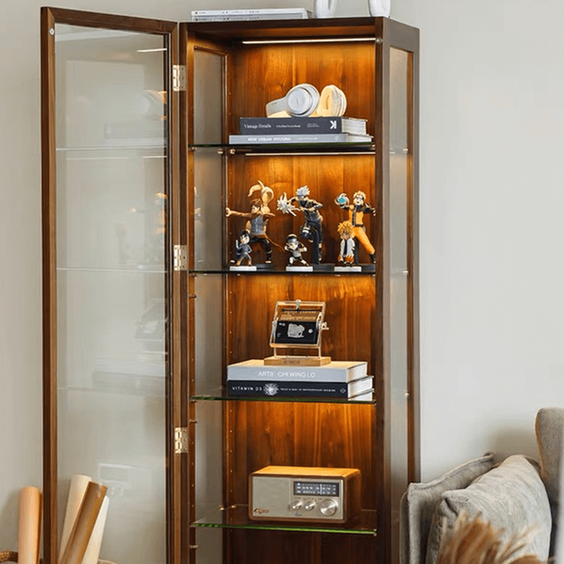 Front view of walnut cabinet showcasing glass shelves with decorative items