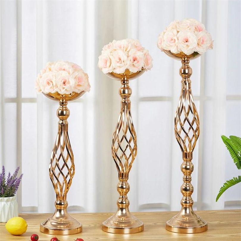 Elegant metal flower holder centerpiece displayed on a beautifully set wedding table.