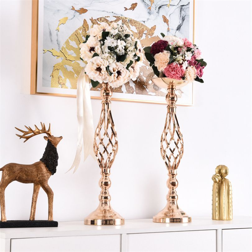 Elegant metal flower holder centerpiece displayed on a beautifully set wedding table.