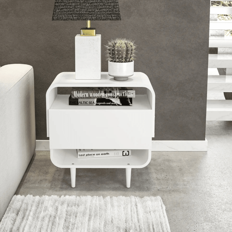 Chic modern white nightstand showcasing drawer and shelves from a side angle.