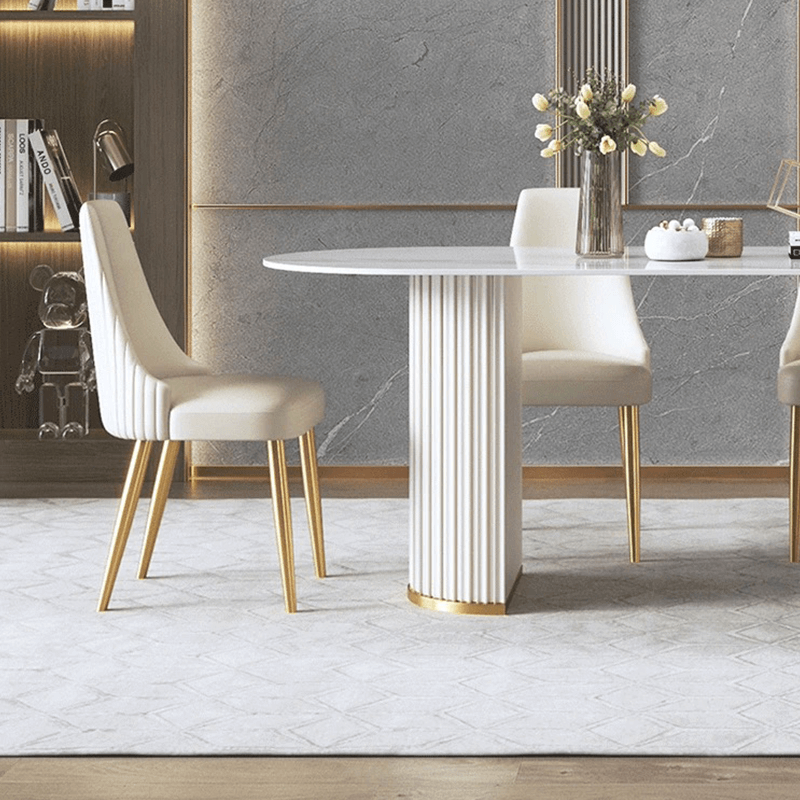 Close-up of the oval marble dining tables elegant veining and sturdy cylindrical legs.