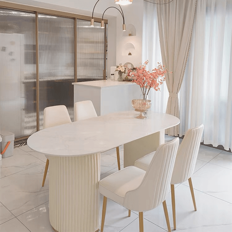 Sleek oval marble dining table showcasing its smooth surface and rounded corners.