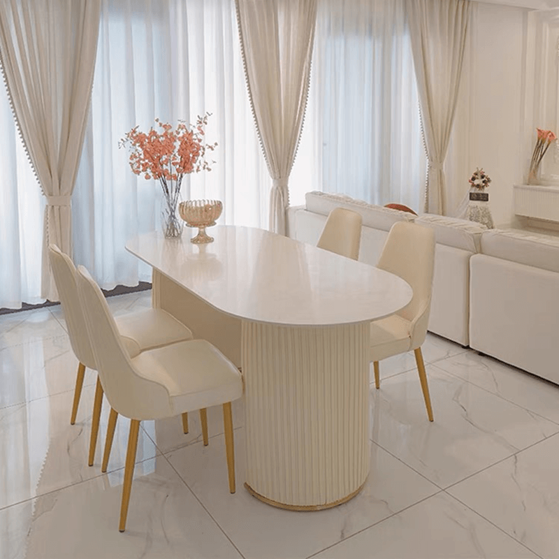 Dining area featuring the modern oval marble dining table with stylish decor.