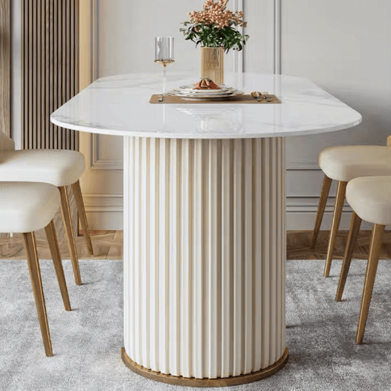 Close-up of the oval marble dining tables elegant veining and sturdy cylindrical legs.
