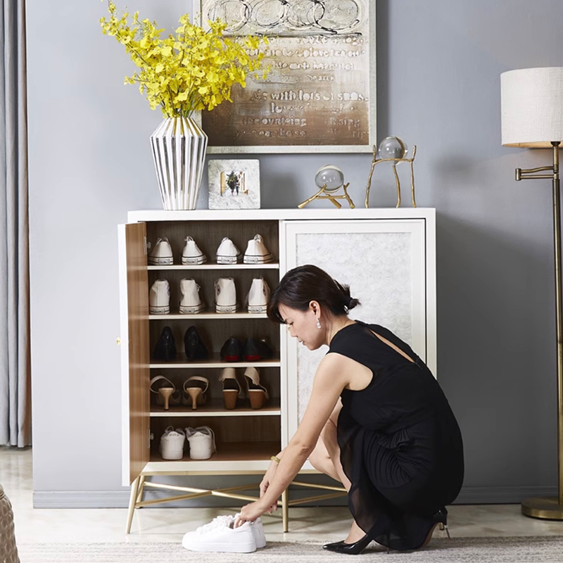 Three-door Nordeluxe white shoe cabinet showcasing adjustable shelving and gold legs