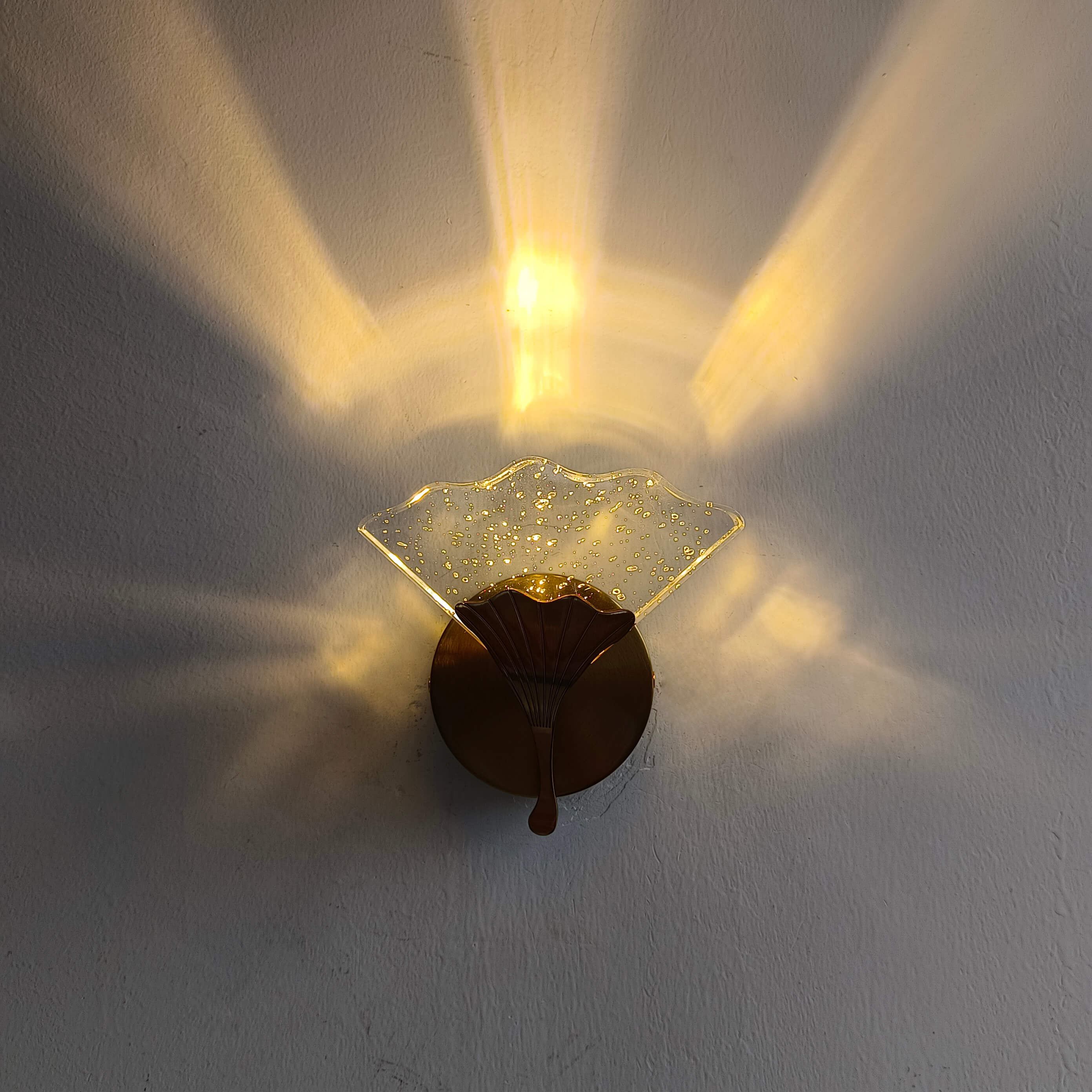 Close-up of the crystal shade detailing in the ginkgo leaf wall light, highlighting its craftsmanship.