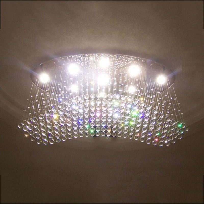 Close-up of the polished chrome ceiling canopy of the crystal light fixture