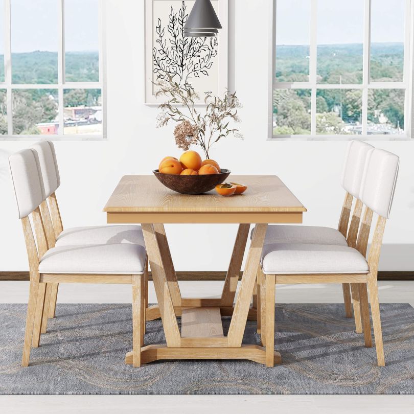 Four comfortable chairs surrounding the rustic dining table, perfect for family gatherings.