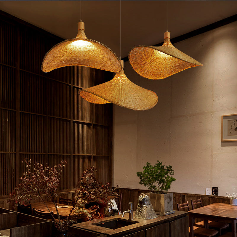 Eco-Chic Bamboo Wicker LED Pendant Light from a side angle in a cozy living room setting.