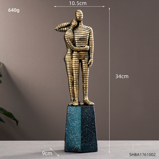 Front view of Nordic resin sculpture on bookshelf, showcasing abstract human form in blue and gold