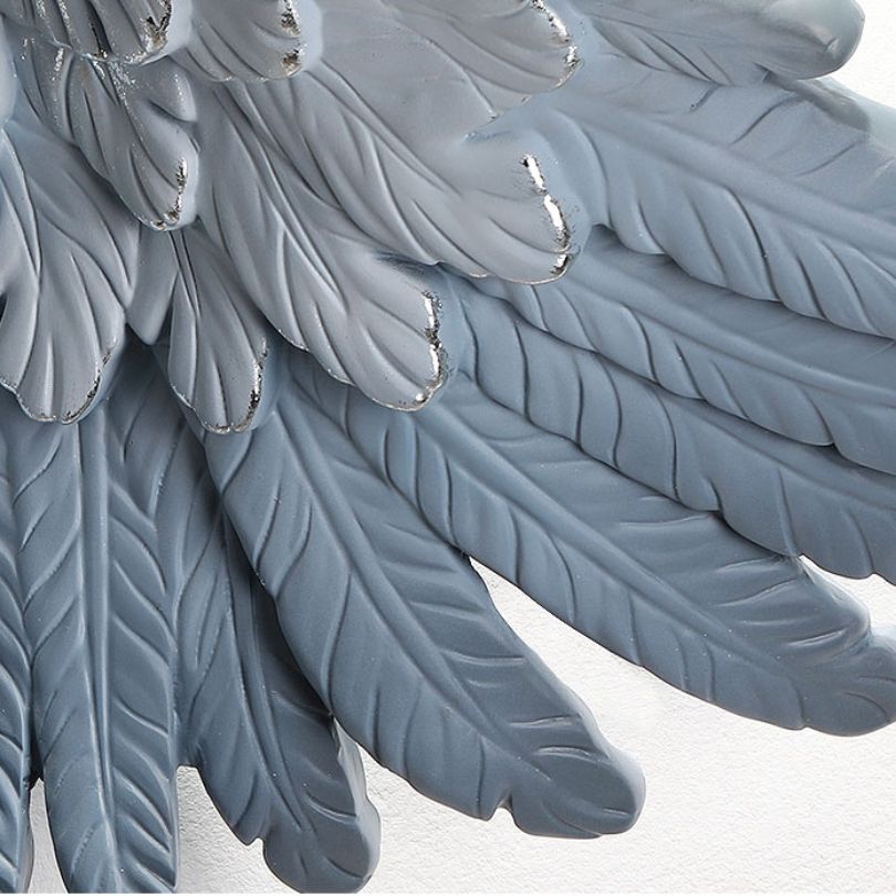 Close-up of Nordic 3D Feather Wall Art in a cozy living room setting, highlighting the vibrant blue color.