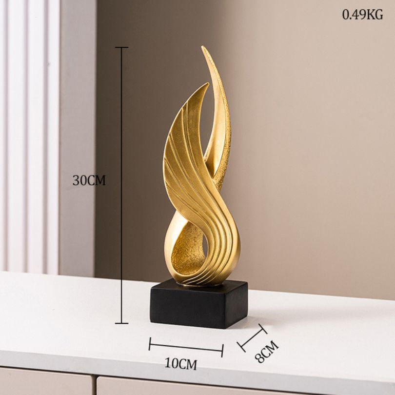 Close-up view of the gold resin abstract wing ornament, highlighting its craftsmanship.