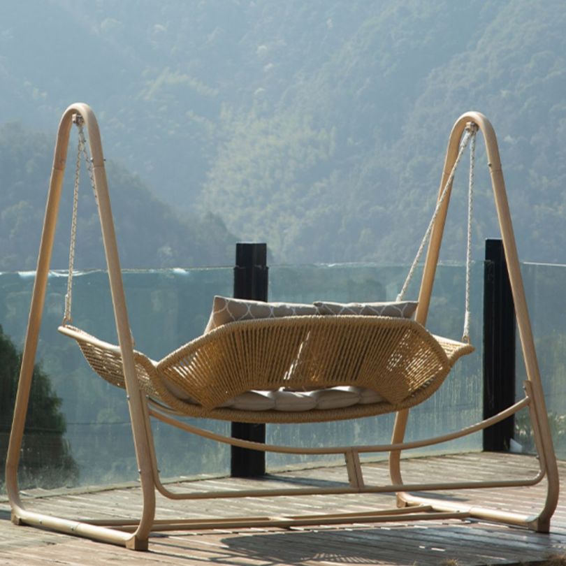 Nordic aluminum swing chair showcasing plush cushion from the side.