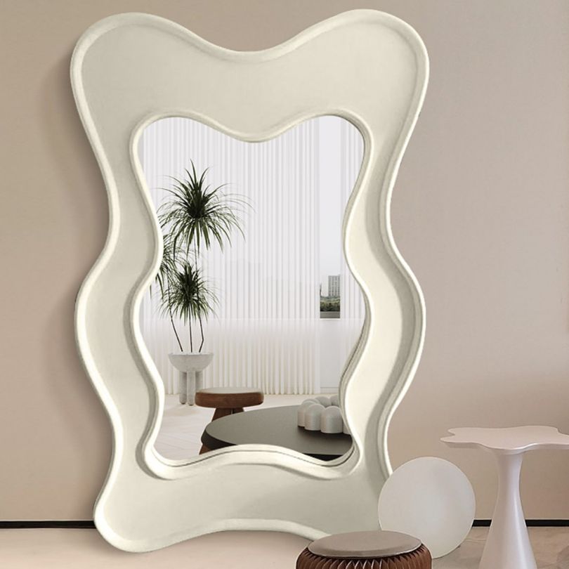 Close-up of the intricate wavy design of the floor mirror showcasing its unique features