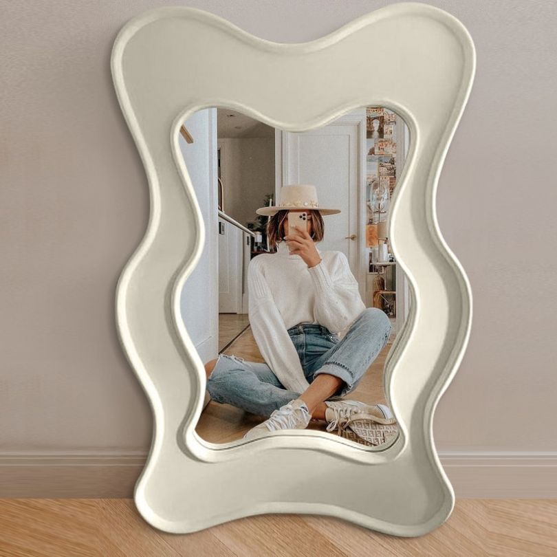 Close-up of the intricate wavy design of the floor mirror showcasing its unique features