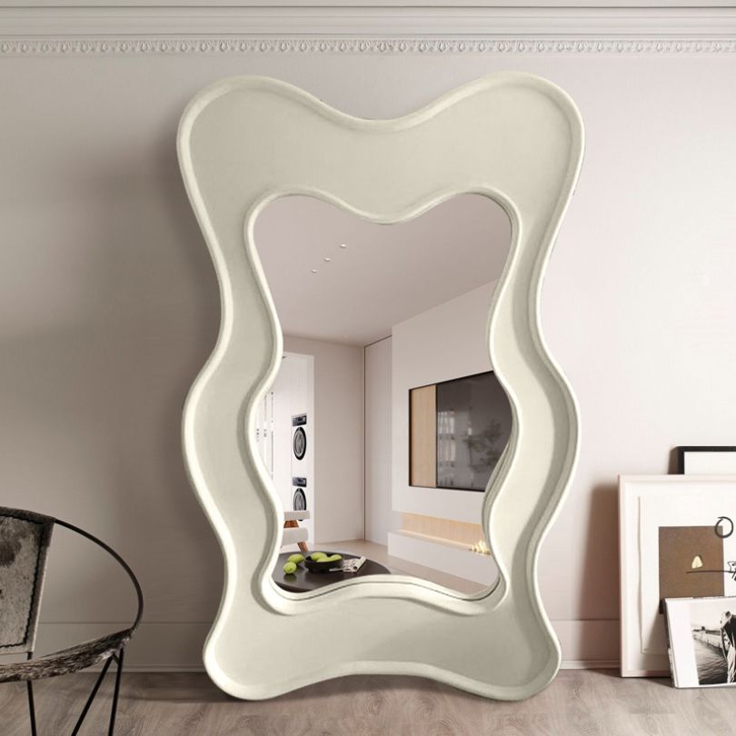 View of the Nordic Wave Asymmetrical Floor Mirror reflecting natural light in a cozy corner