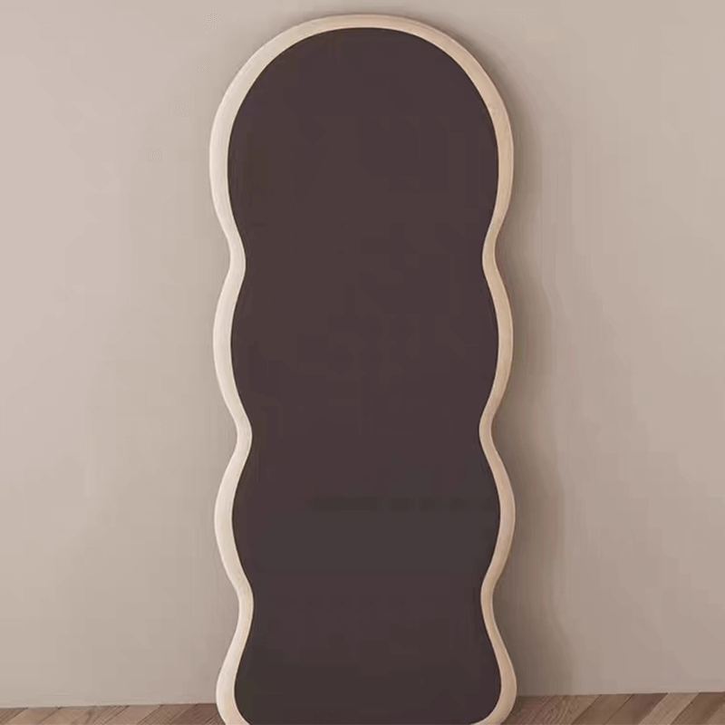 Full length mirror mounted on the wall reflecting a stylish outfit, perfect for checking your appearance.