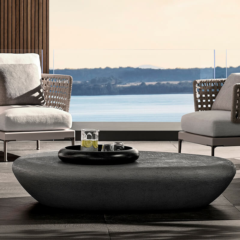 Close-up of the concrete surface of the Nordic Oval Outdoor Coffee Table highlighting its sturdy construction.