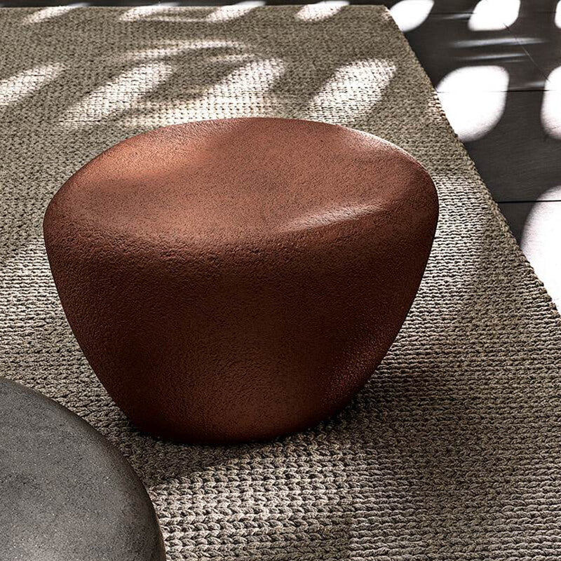 Side angle of the Nordic Concrete Coffee Table set up in a patio environment, ideal for outdoor gatherings.