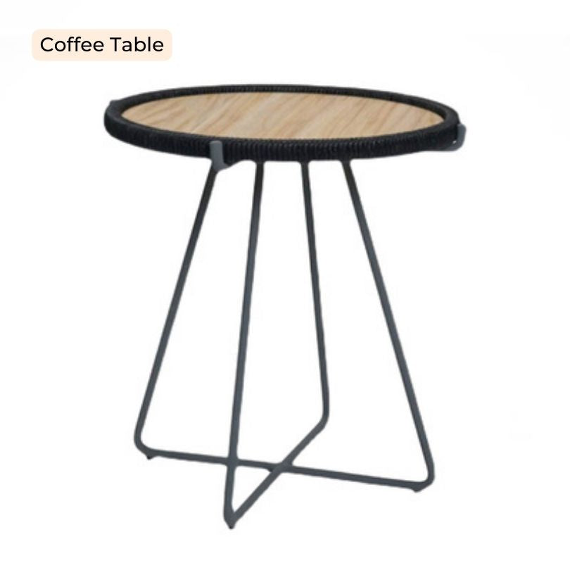 The complete Nordic outdoor seating arrangement with a footstool and coffee table in a garden setting.