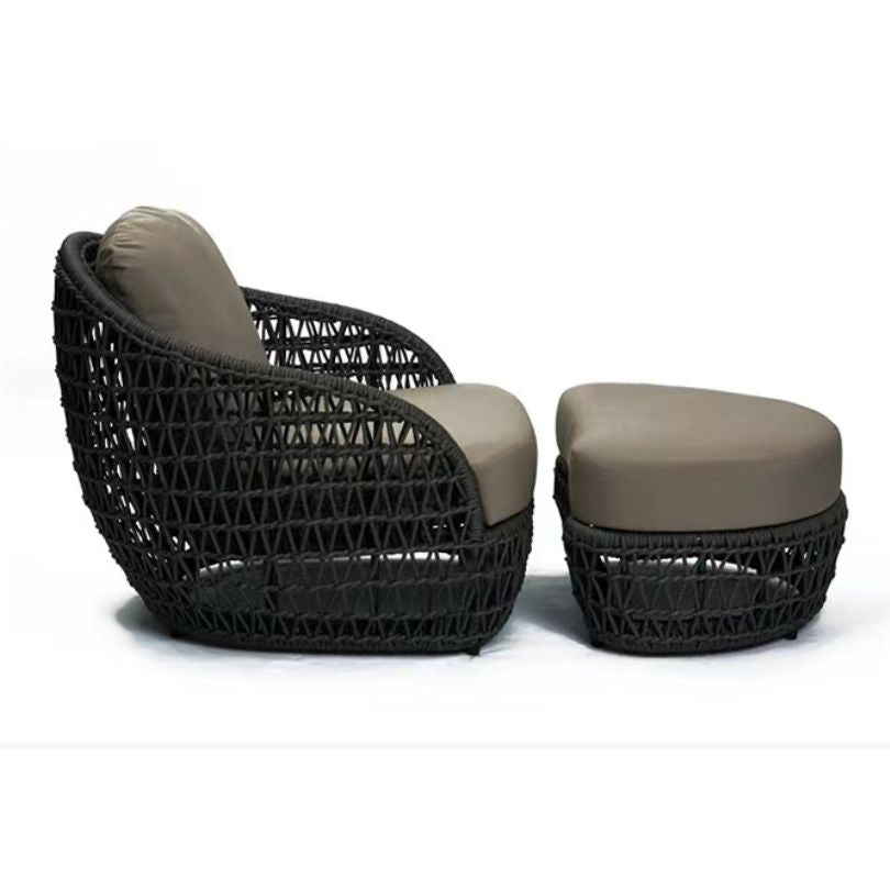 The complete Nordic outdoor seating arrangement with a footstool and coffee table in a garden setting.