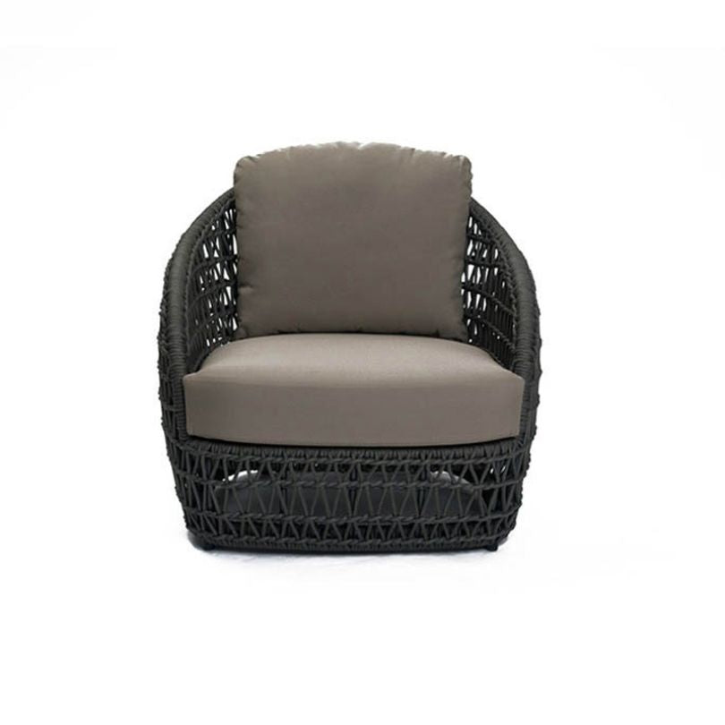 The complete Nordic outdoor seating arrangement with a footstool and coffee table in a garden setting.