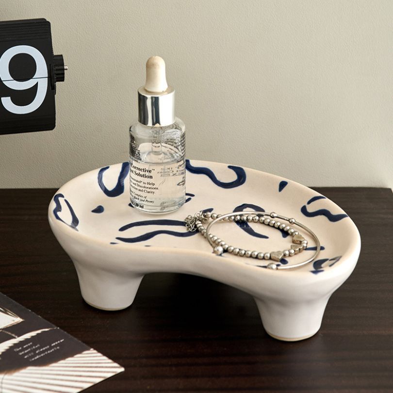 Elegant ceramic storage tray displayed on a stylish table