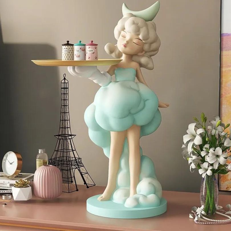Close-up of the Nordic girl figurine with tray on a living room shelf