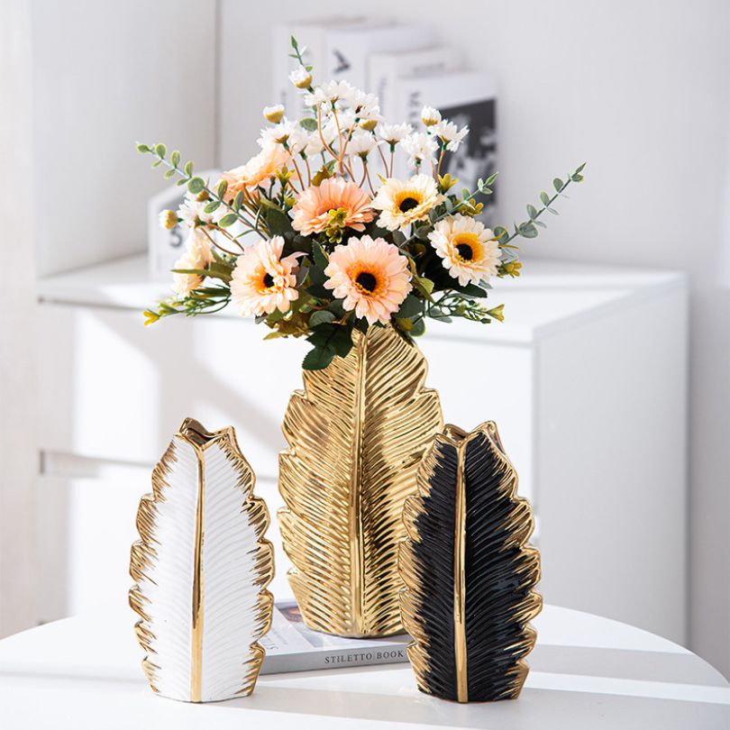 Close-up of the pleated leaf design on the Nordic gold ceramic vase, showcasing its intricate details.