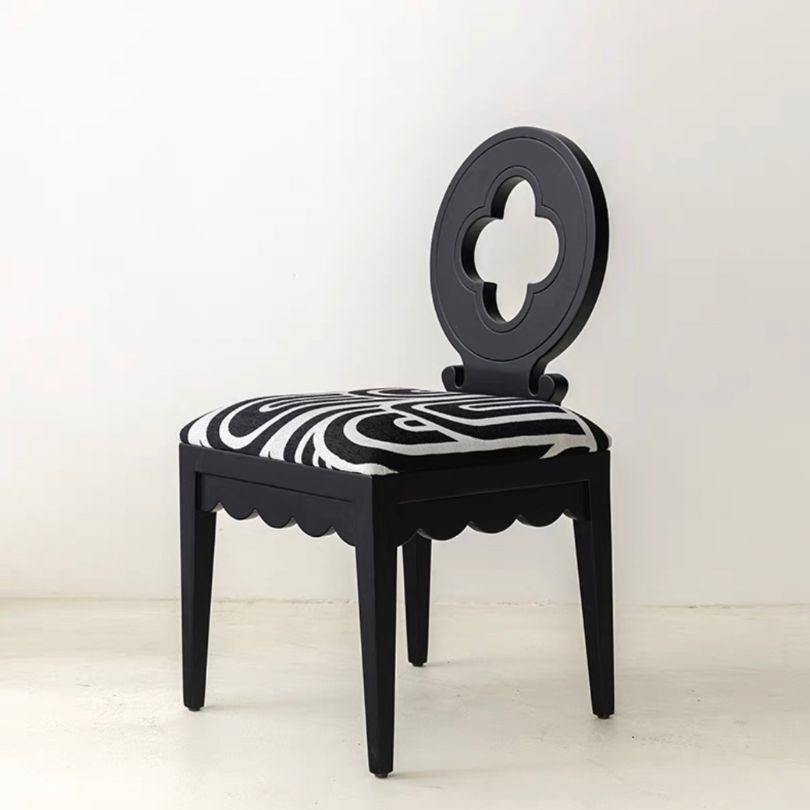 Nordic Hollow Clovers chair with cushion in white, showcased in a bright dining room.