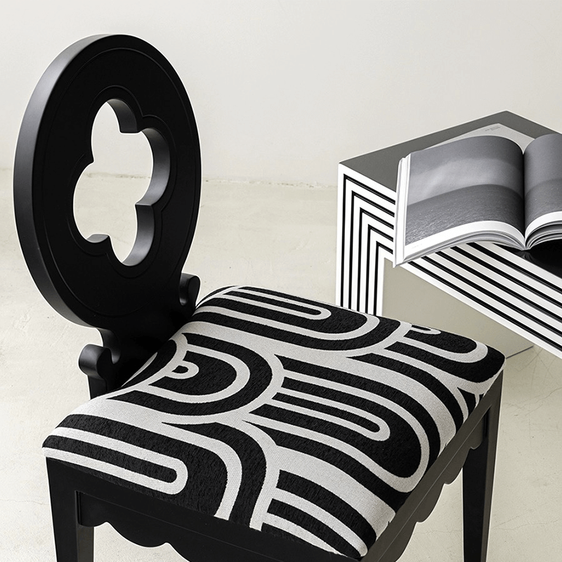 Nordic Hollow Clovers chair with cushion in white, showcased in a bright dining room.