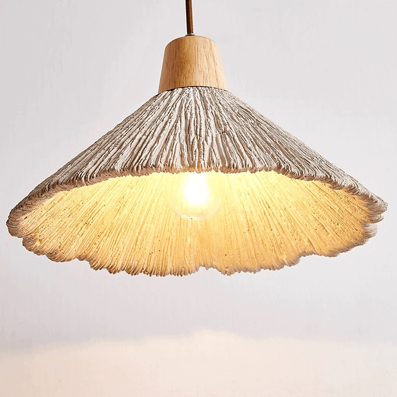 Nordic LED pendant light with cement design hanging above a dining table