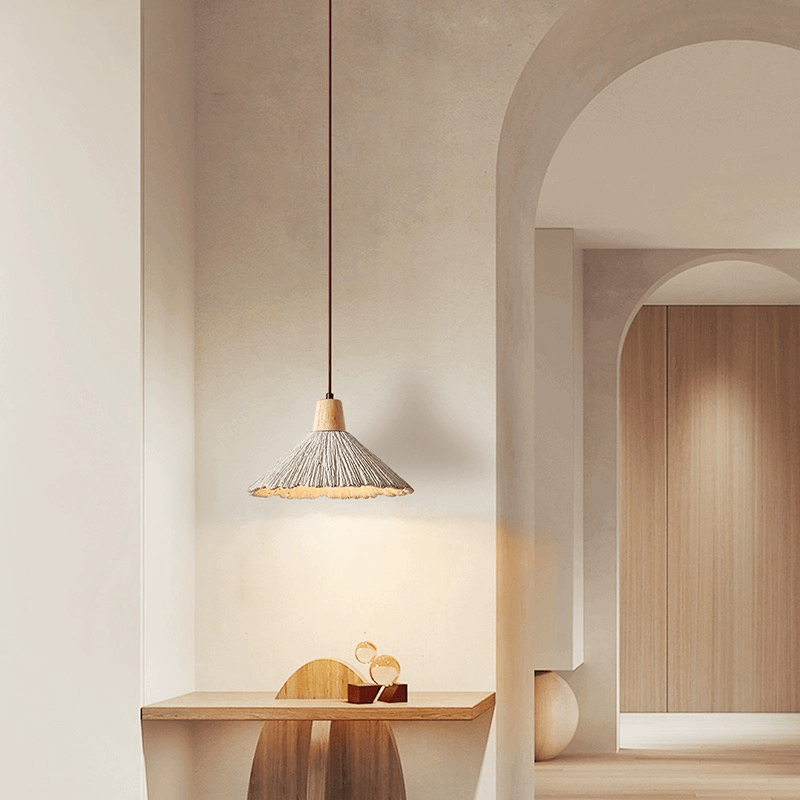 Nordic LED pendant light with cement design hanging above a dining table