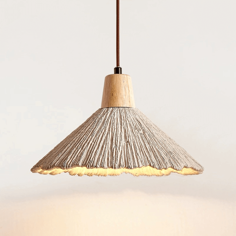 Close-up of the creamy cement shade and wooden accents of Nordic pendant light