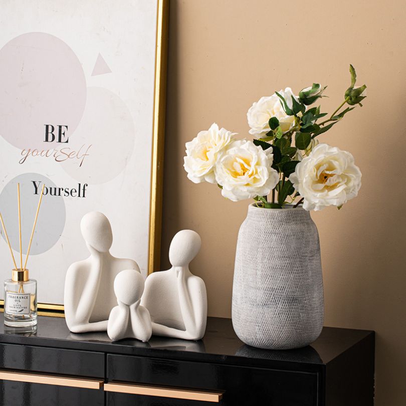Stylish Nordic ceramic vase on a dining table, beautifully displaying fresh flowers.