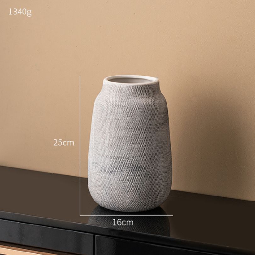 Stylish Nordic ceramic vase on a dining table, beautifully displaying fresh flowers.