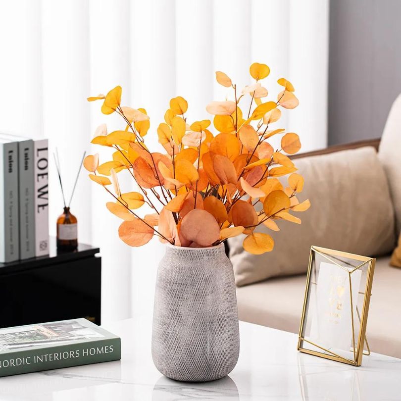 Stylish Nordic ceramic vase on a dining table, beautifully displaying fresh flowers.