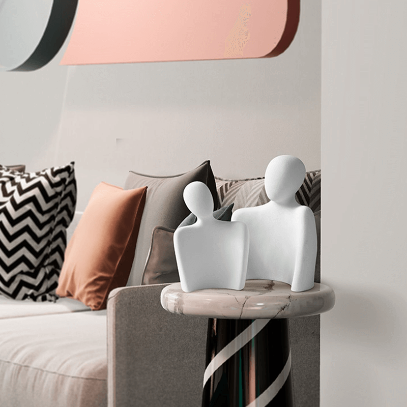 Nordic Embrace Couple Ceramic Sculpture placed on a shelf, enhancing home decor.