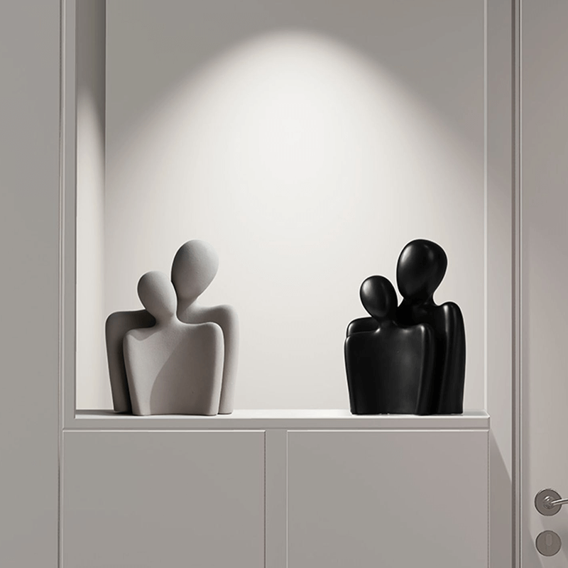 Nordic Embrace Couple Ceramic Sculpture displayed in a modern living room setting.