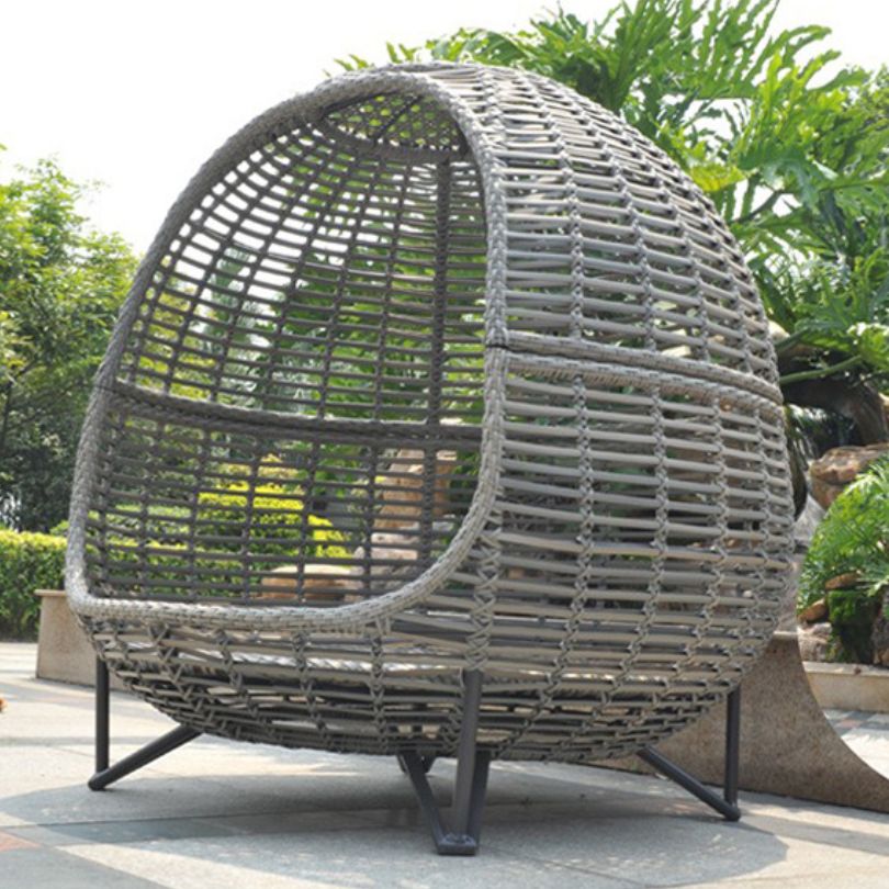 A cozy view of the Nordic outdoor rattan daybed showcasing its elegant design and canopy.