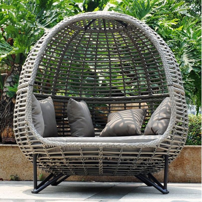 Close-up of the waterproof cushions on the customizable rattan daybed, perfect for outdoor lounging.