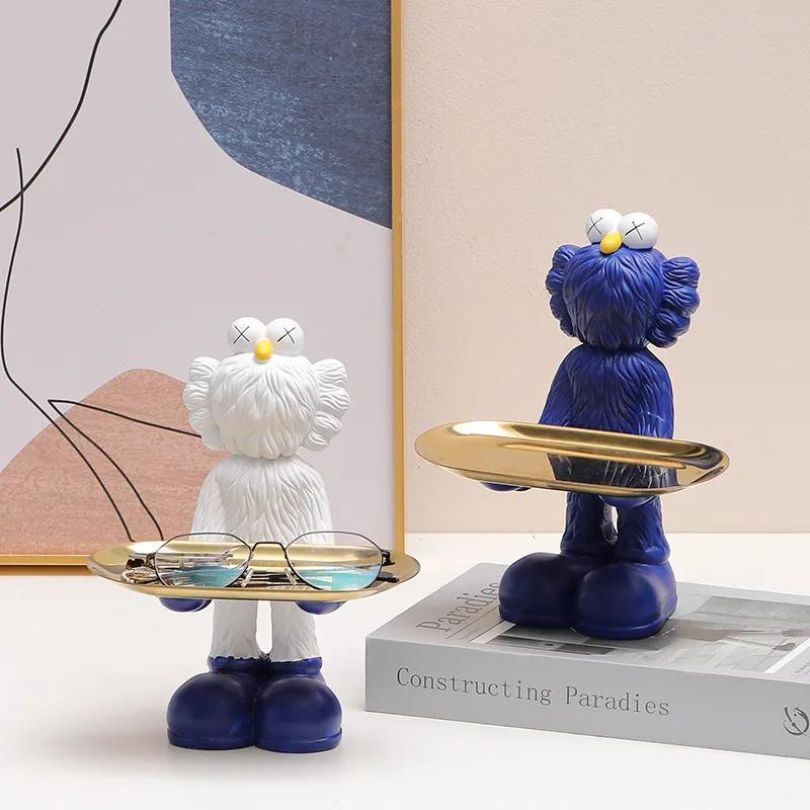 Elegant Nordic resin doll with tray in a bright living room setting.